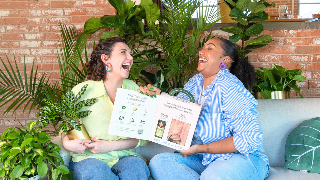 Women smiling and laughing around plants